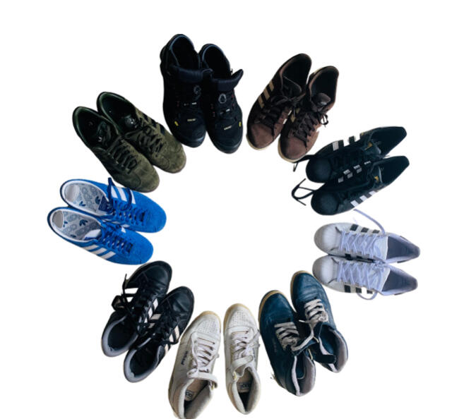 Nine pairs of Adidas trainers arranged in a circle